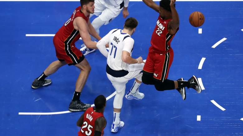 Mavericks' Luka Doncic comes up limping after injuring his ankle.